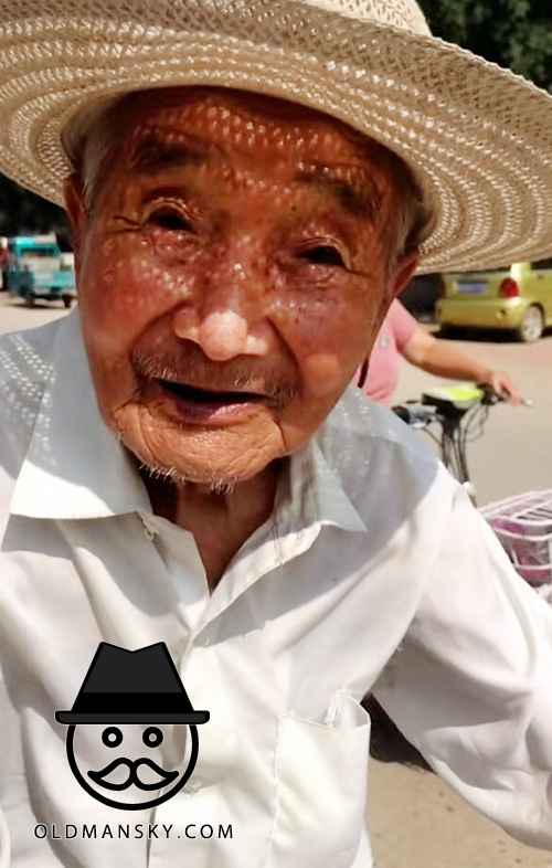 White shirt old man went to shop by bike