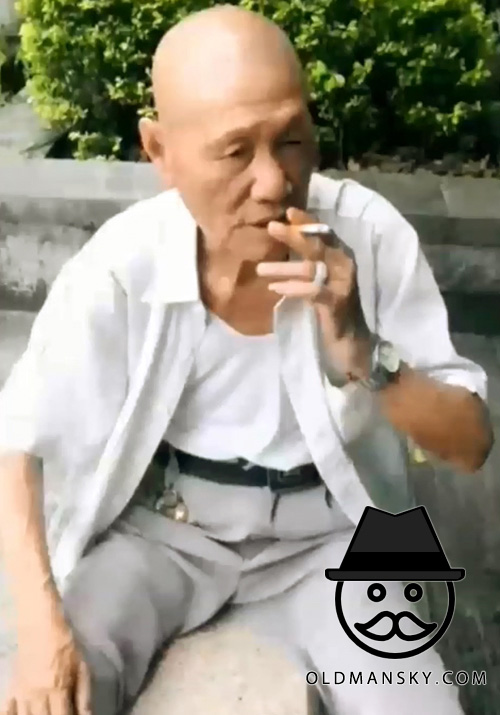 White shirt bald head old man smoke in the park
