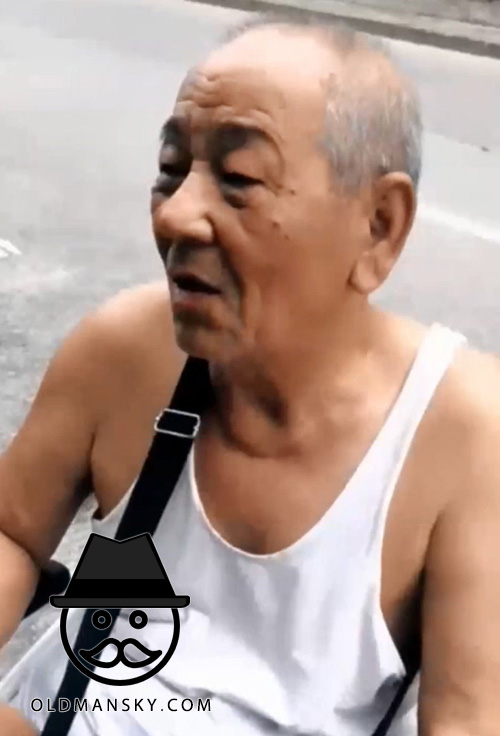 Old man in white vest undershirt talked on the wheelchair