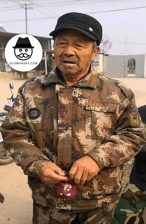 Old man wore a hat and military uniform at home