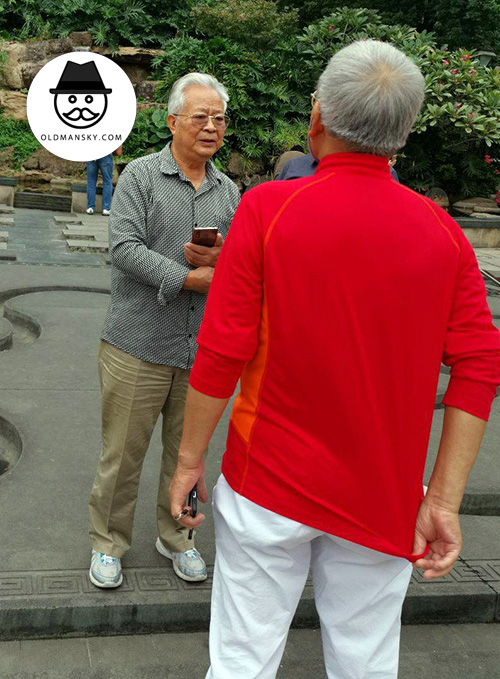 Two white hair old men talked in the park