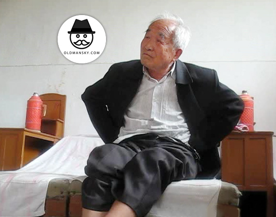 White hair old man wore black suit in the rest-room