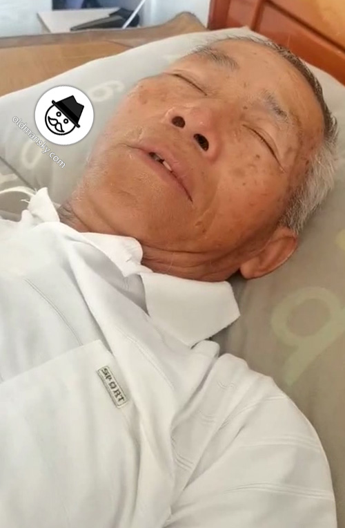White hair old man wore white polo shirt slept in the bed