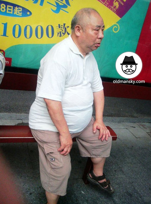 Fat old man wore white polo shirt was waiting bus in the bus station ...