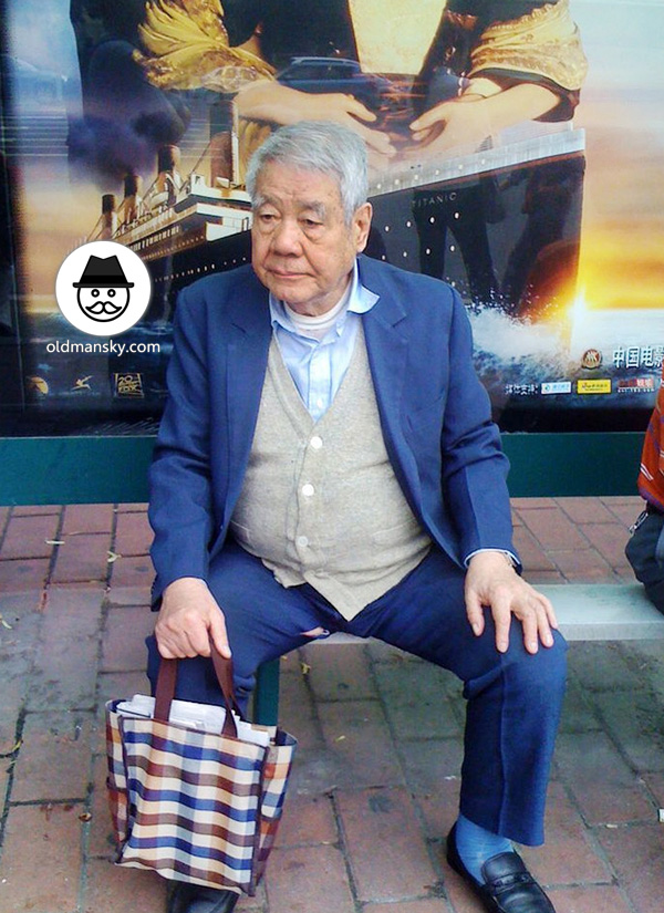 White hair old man wore blue suit was waiting bus in the bus station