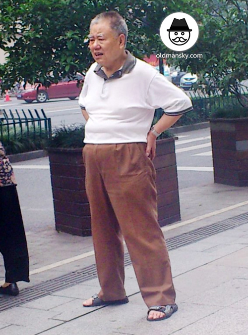 Old daddy wore white polo shirt and coffee pants was exercising in the street