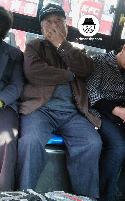 Old man wore a cap and coffee color jacket by bus