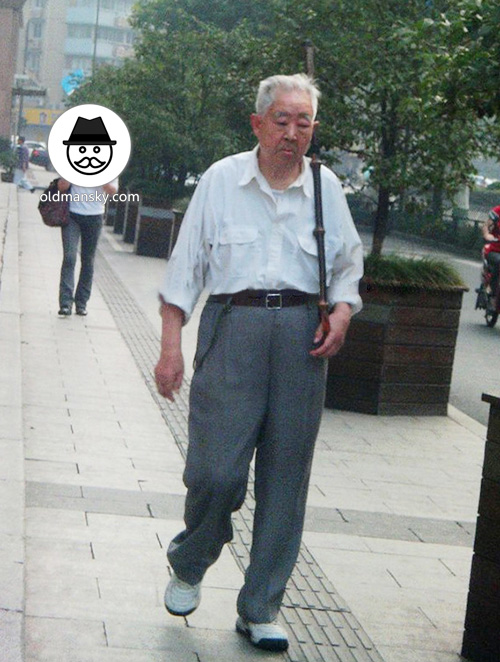 White hair old man wore white shirt went shopping in the street