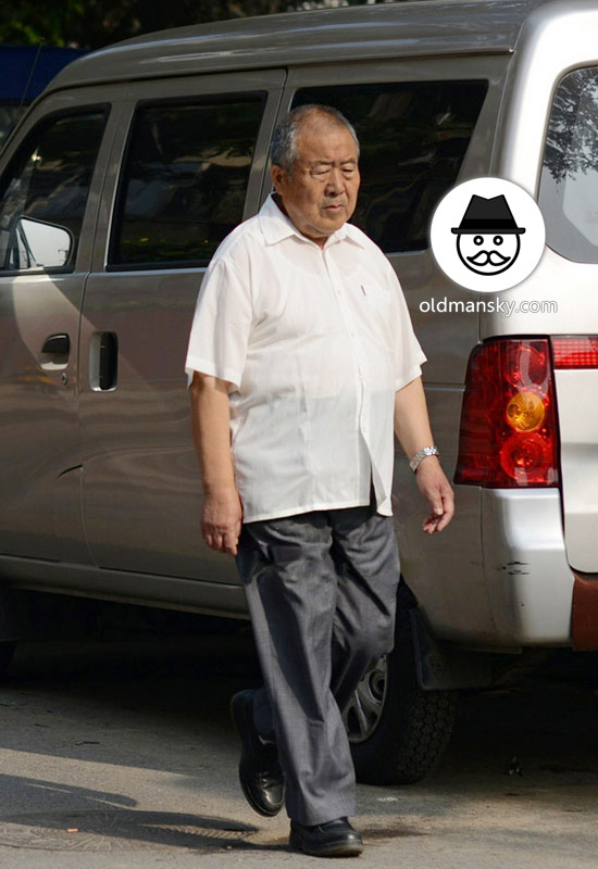 Old man wore white shirt was walking in the street