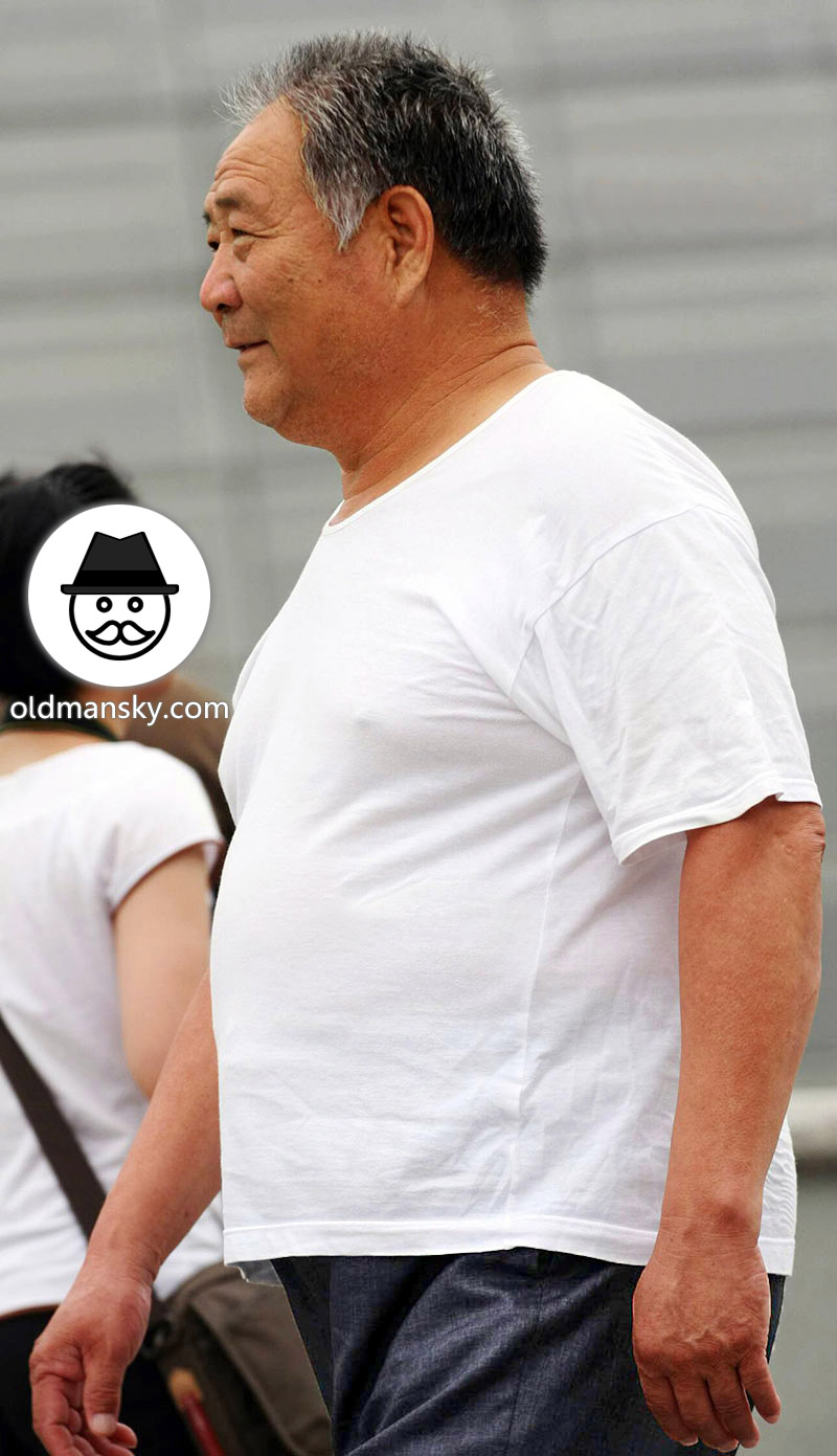Fat old daddy wore white undershirt walked in the park