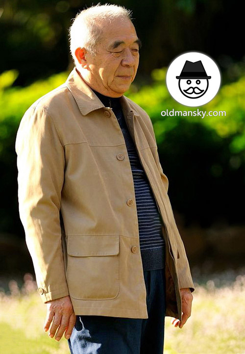 Old man wore yellow jacket and brown trousers in the park