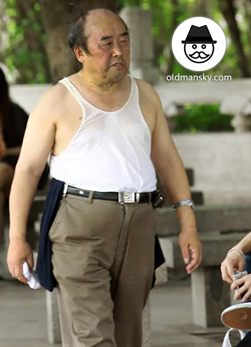 Old daddy wore white vest undershirt and green trousers in the park