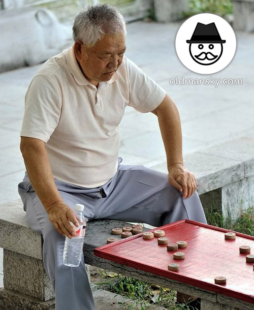 White hair old man wore a blue trousers was playing Chinese chess in the park_03