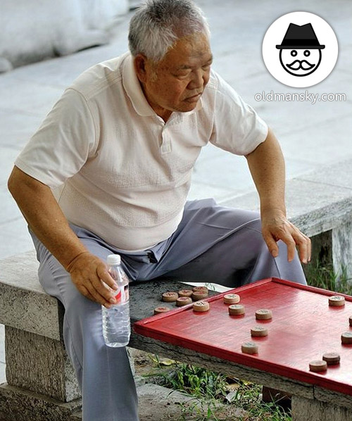 White hair old man wore a blue trousers was playing Chinese chess in the park_04