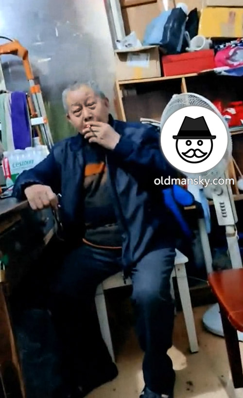 Old daddy was smoking and talking in the room