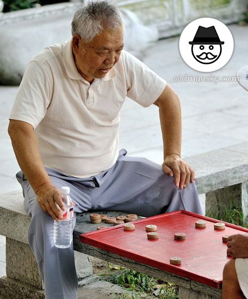 White hair old man wore a blue trousers was playing Chinese chess in the park_06