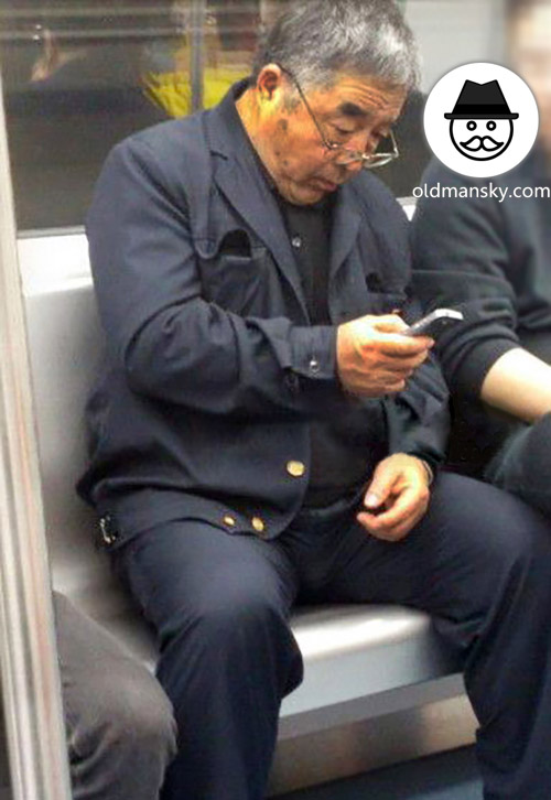 Glasses old daddy wore black suit was watching cellphone by subway_02