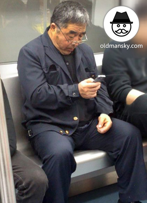 Glasses old daddy wore black suit was watching cellphone by subway_03