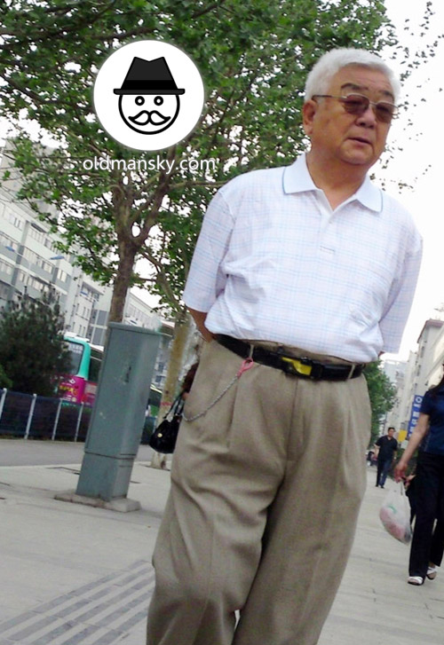 White hair glasses old man wore white polo shirt was walking in the street
