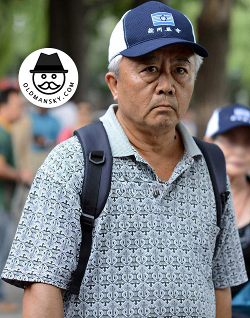 Tourist white hair old man wore cap and plaid polo shirt in his trip