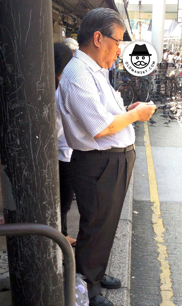 Handsome glasses old daddy was waiting bus in the bus station