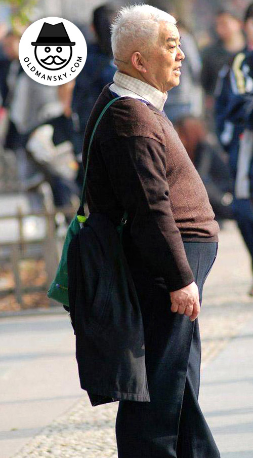 White hair old man wore coffee sweater in his trip