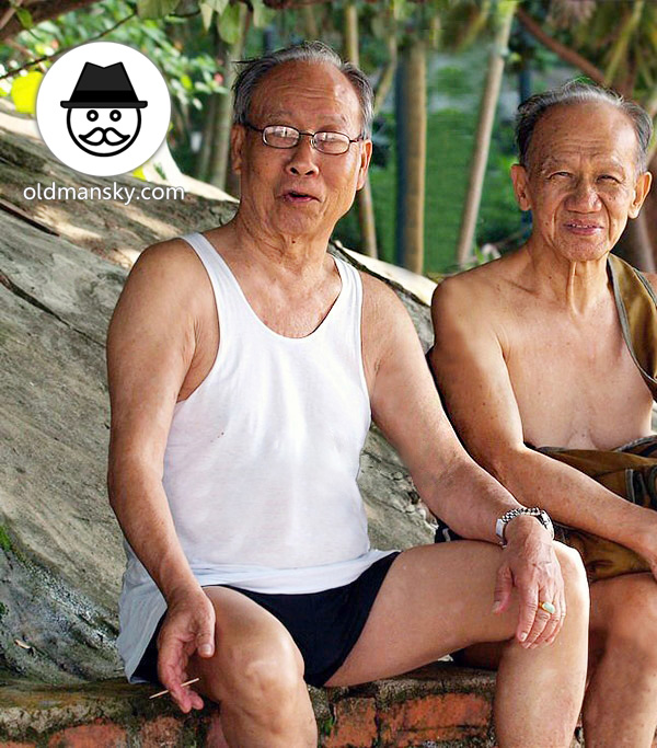 Two old men rest on the stone under the tree