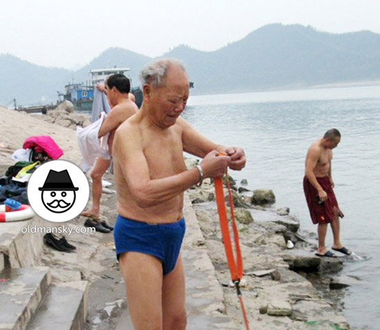White hair old man wore blue underwear went swimming by the river