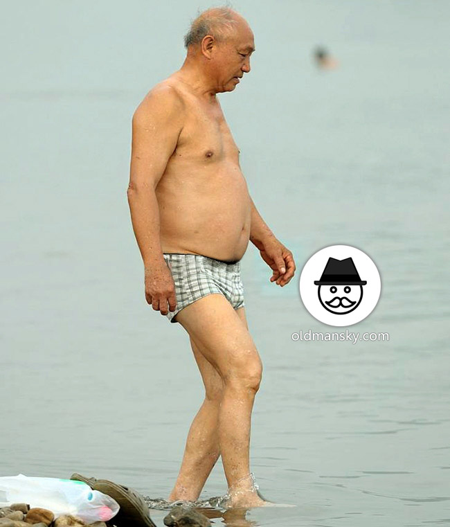 Silver hair old man went swimming by the lake