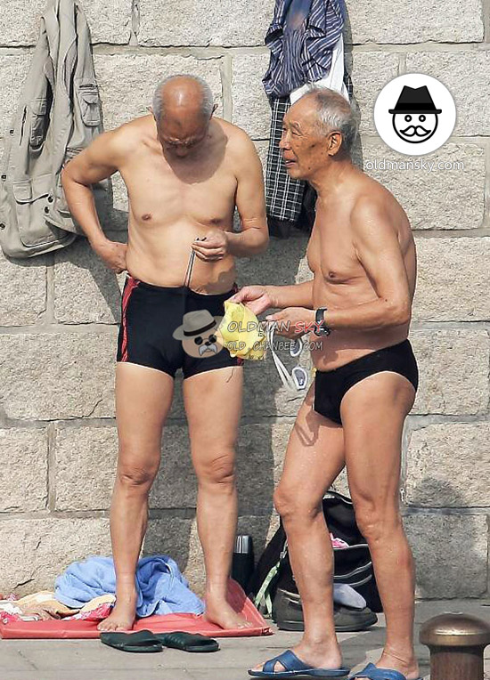 Thin swimming old man wore a black underwear stood by the river