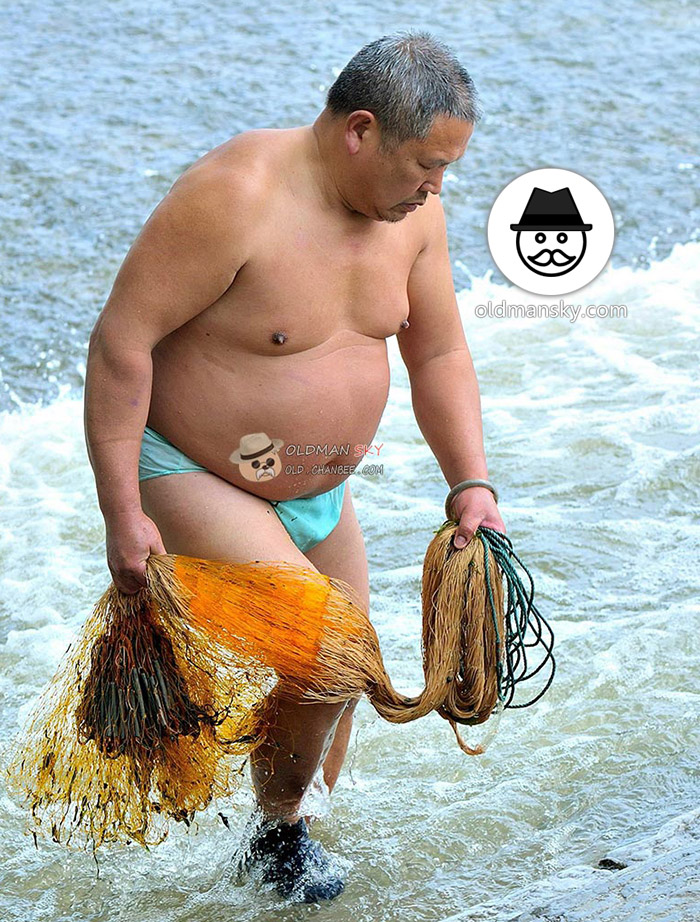 Fat old daddy was fishing with a fishing net by the seaside