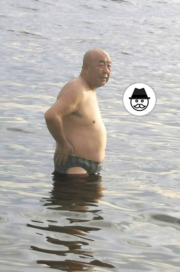Bald head swimming old daddy wore a strip underwear stood at the sea