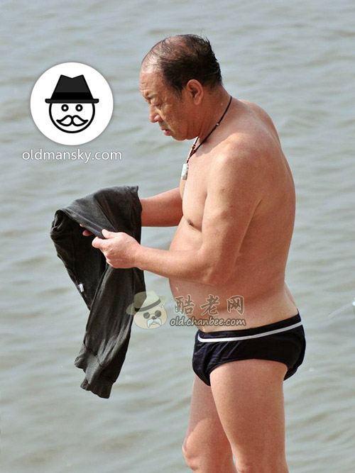 Old daddy wore a black underwear ready to swim stand by the river