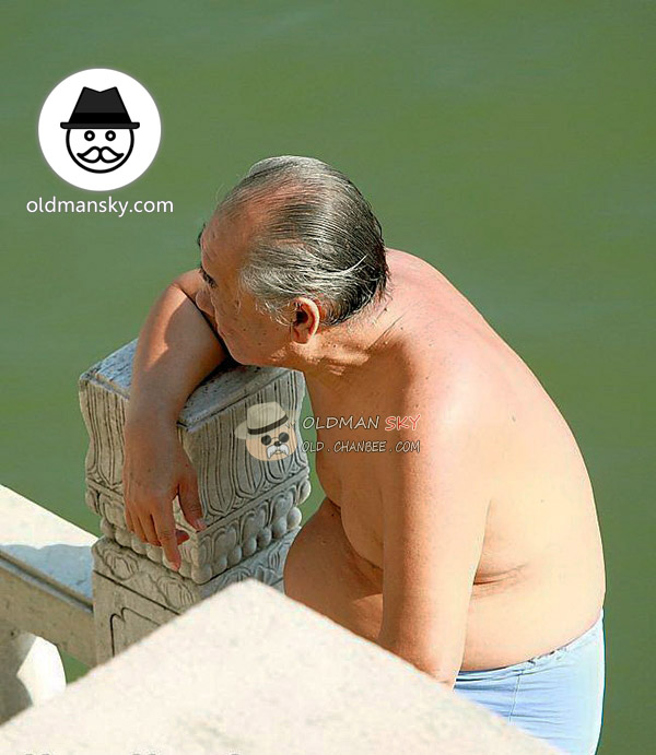 Fat swimming old man wore a blue underwear sat by the river
